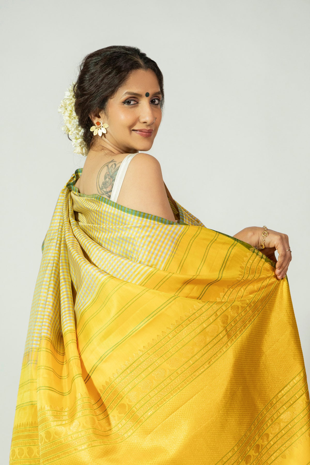 Arishina Chukki Molakalmuru silk saree featuring vibrant yellow body with elegant contrast border and pallu