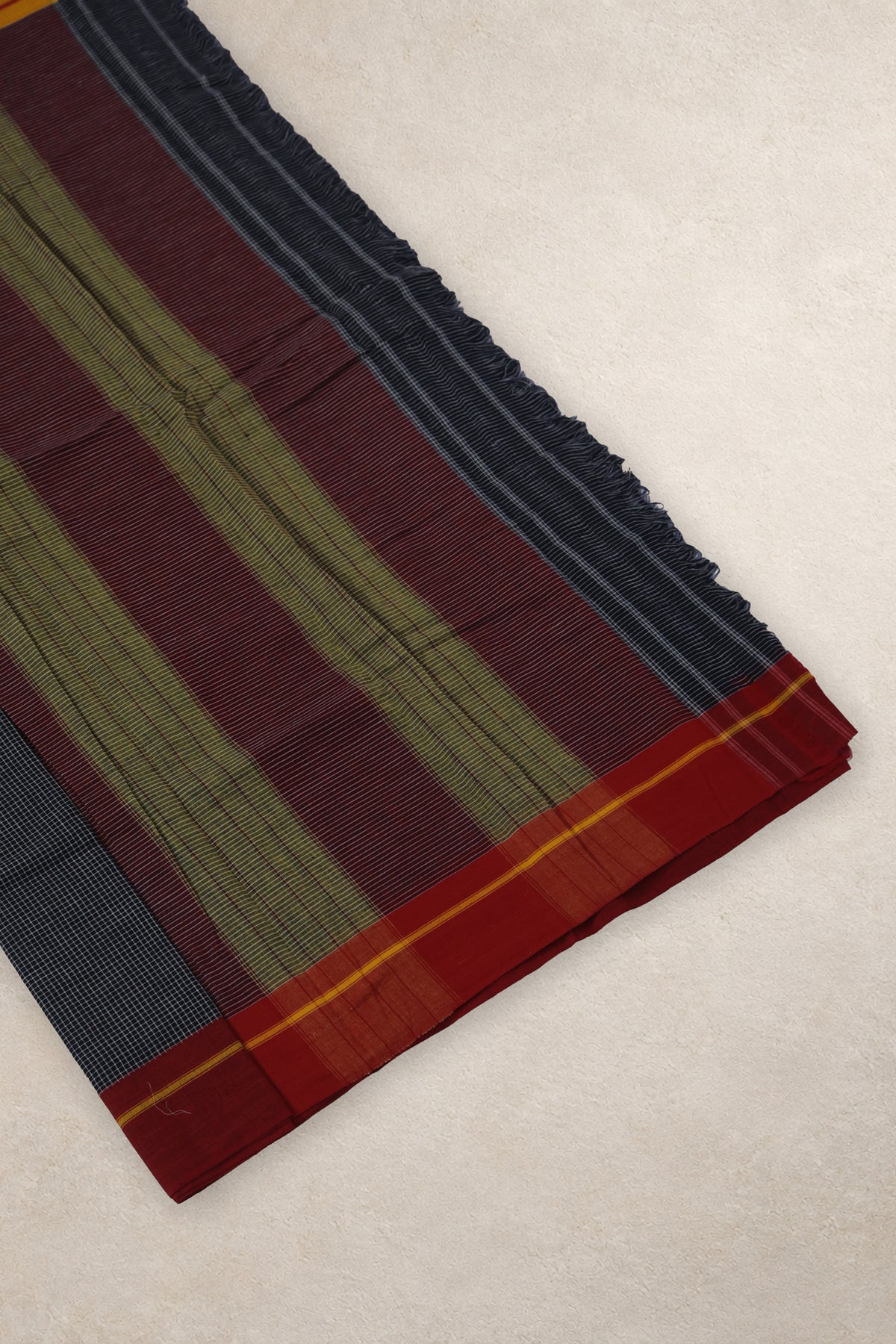 Close up of fine black white checks and red yellow Ganga Jamuna border