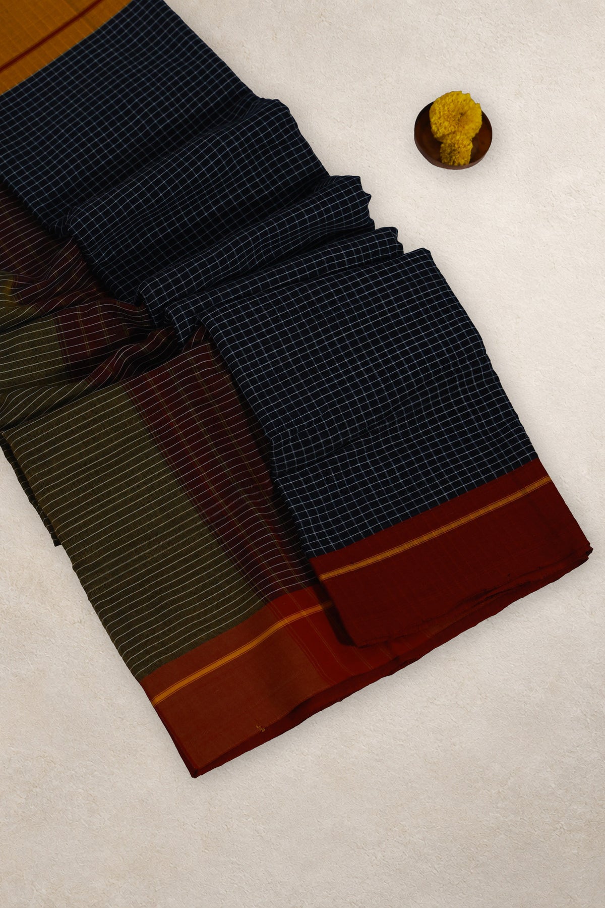 Green and black striped pallu of Kumkuma Arishina cotton saree