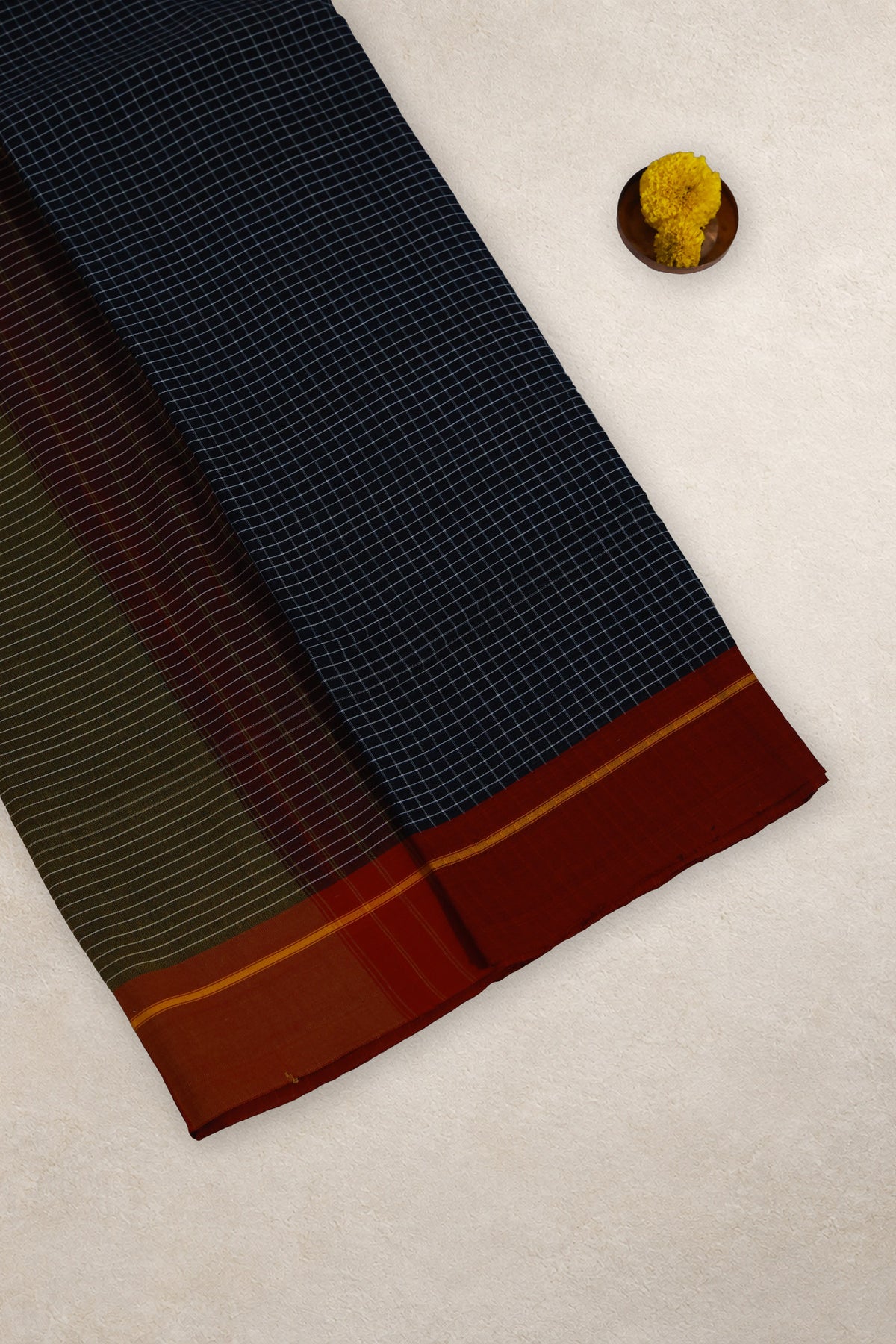Close up of black white checks and red yellow Ganga Jamuna border