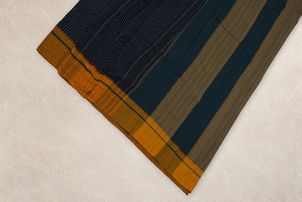 Close up of black white checks and green yellow Ganga Jamuna border