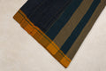 Close up of black white checks and green yellow Ganga Jamuna border