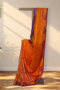 Komola Neel orange Kalakshetra silk saree with ikat border and teal blue pallu