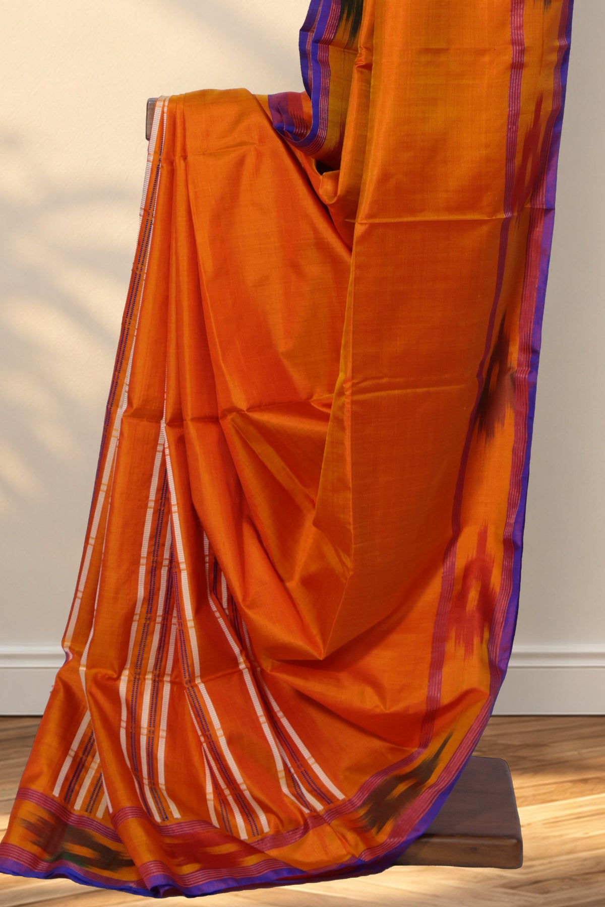 Plain orange Kalakshetra silk saree with contrasting ikat border