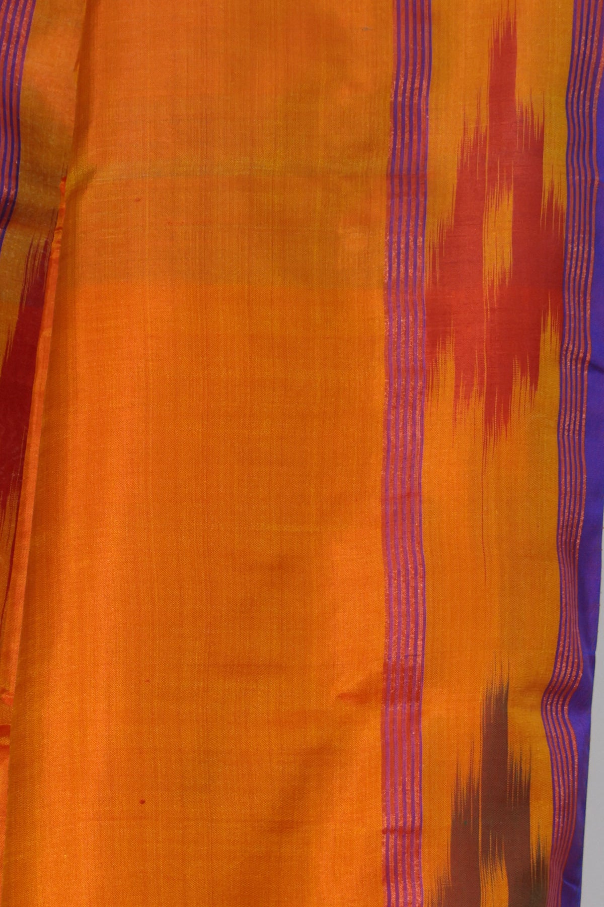 Teal blue pallu with white and red woven stripes on Komola Neel saree