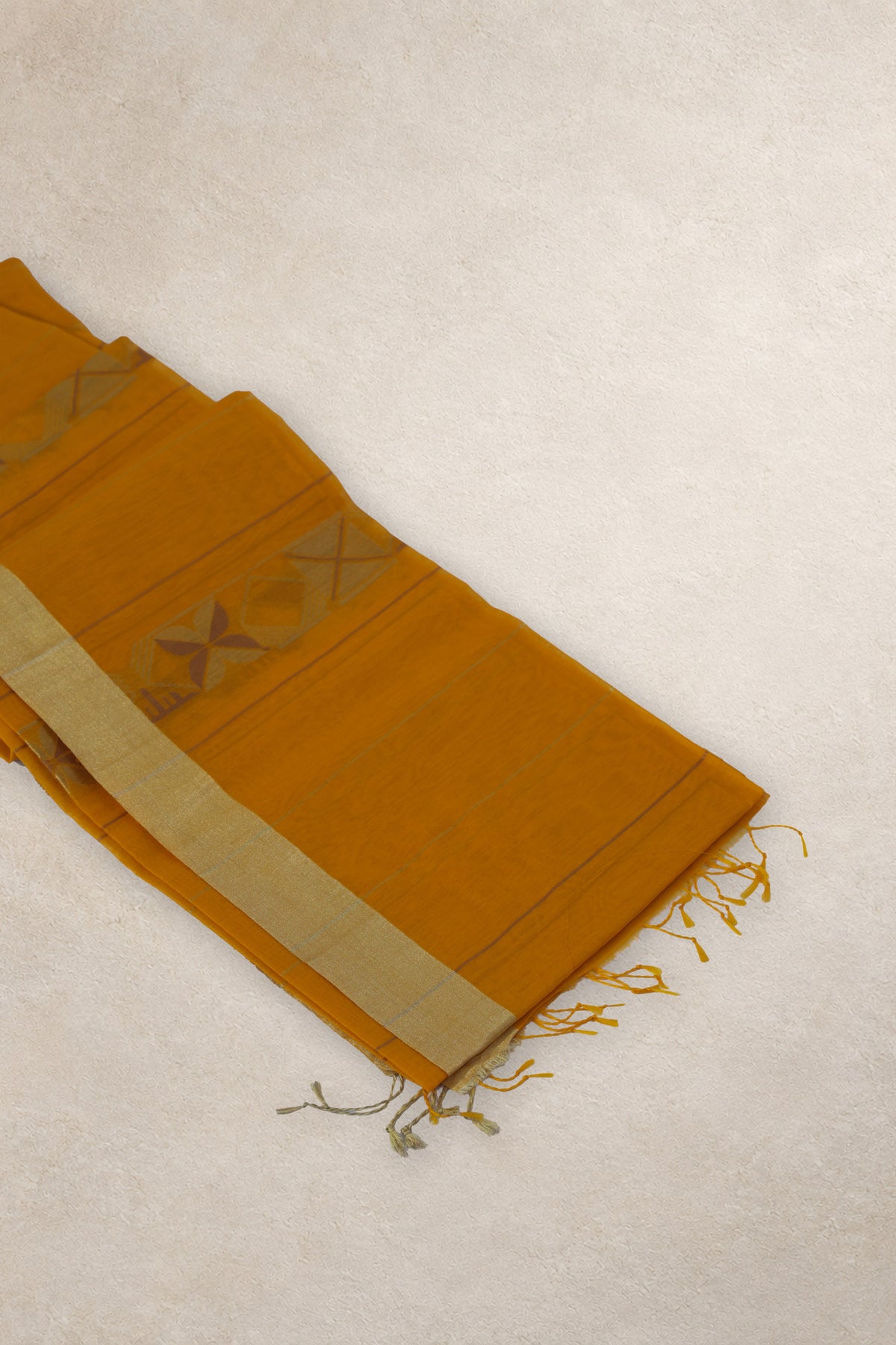 Close up of geometric motifs and light purple details on turmeric Chanderi silk