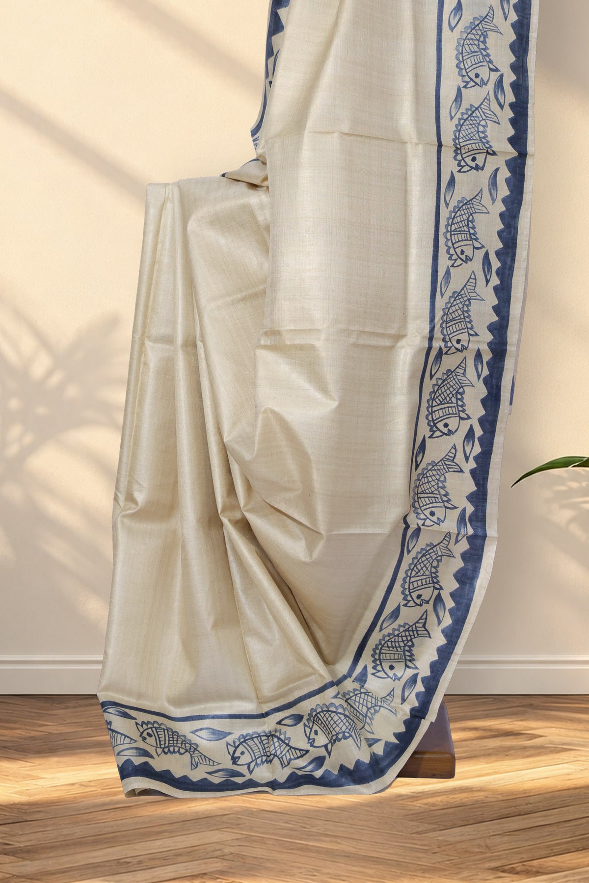 Ivory Batik Tussar saree with plain body and black fish motifs