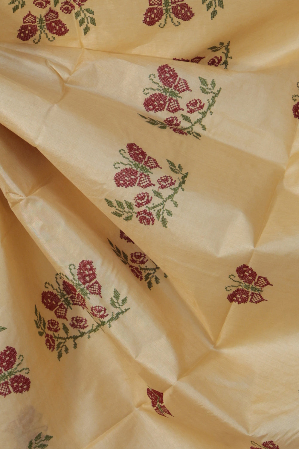 Close up of Aari embroidered butterfly motif on beige Tussar silk