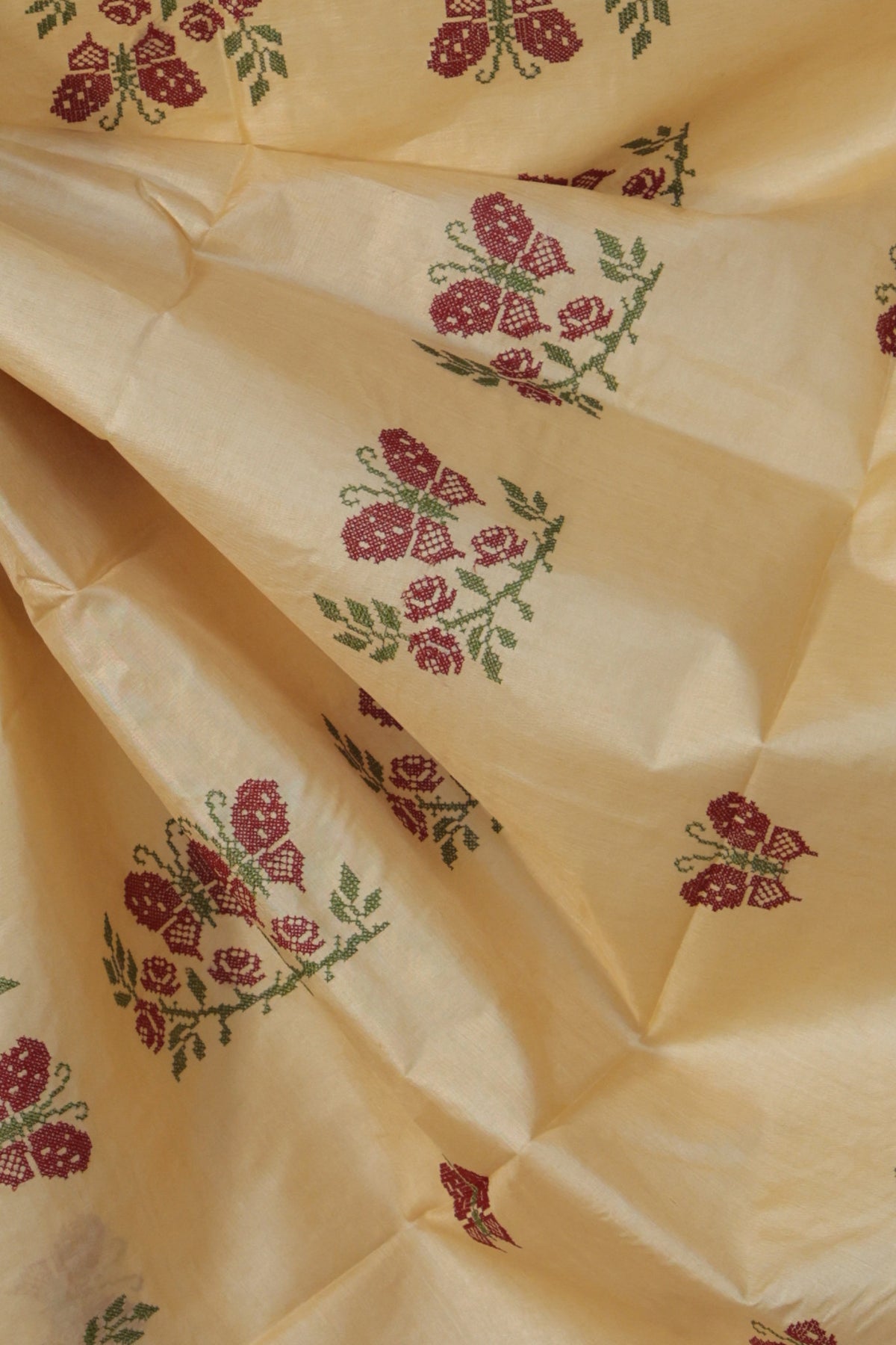 Close up of Aari embroidered butterfly motif on beige Tussar silk