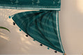 Silver zari and leaf motif border on Hari Chahak green Dabu saree