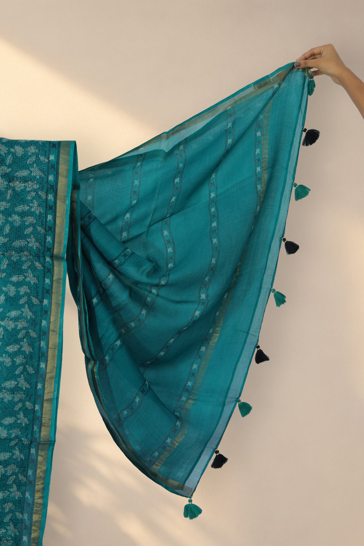 Thin golden zari border on Patti Bel green Dabu silk saree