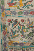 Close up of hand stitched Kantha parrot and leaf motifs on beige Gachi Tussar