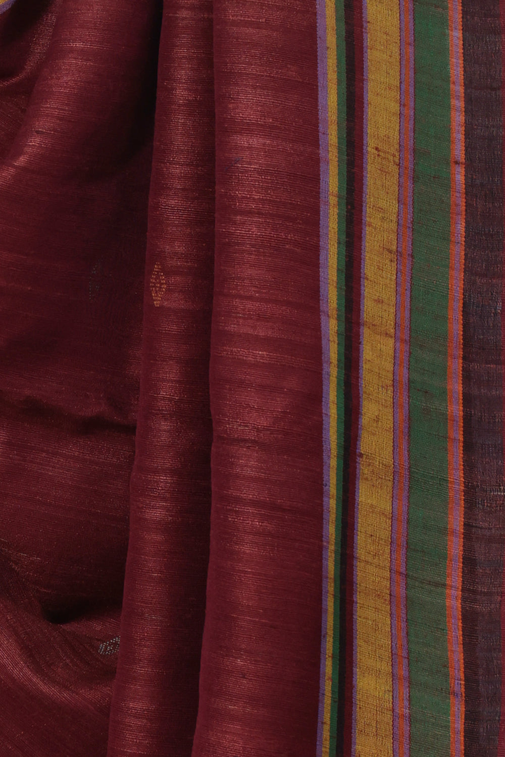 Close up of counted extra weft geometric motifs on maroon Bhujodi Tussar silk