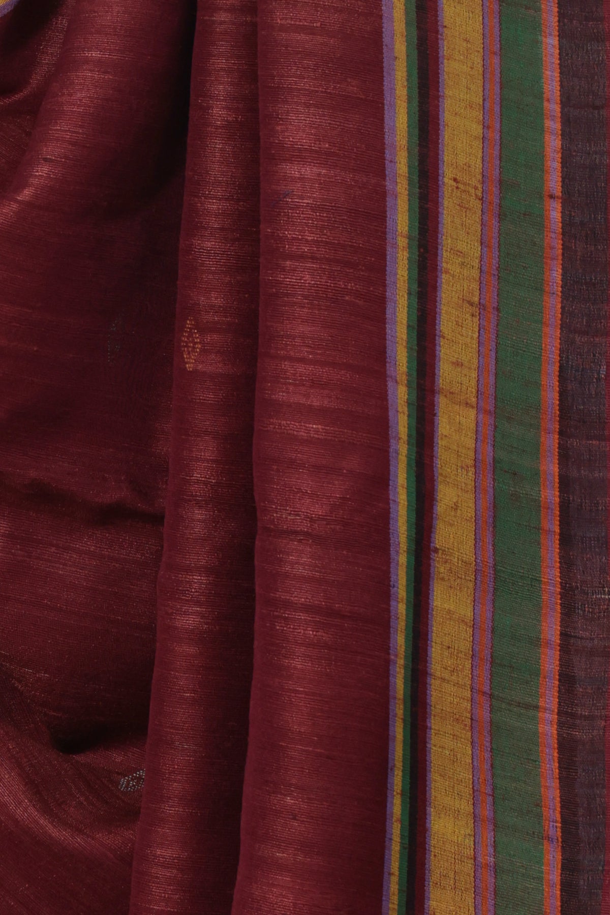 Close up of counted extra weft geometric motifs on maroon Bhujodi Tussar silk
