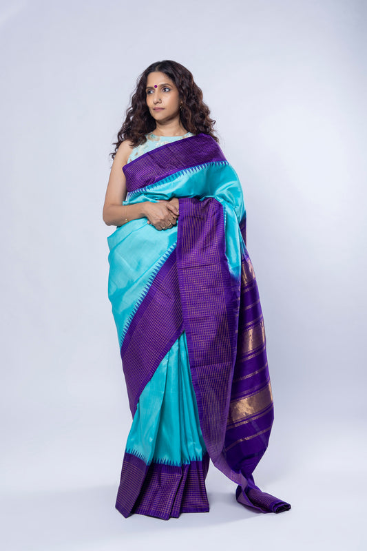 Gopura Neeli teal blue Molakalmuru silk saree with purple and gold temple border