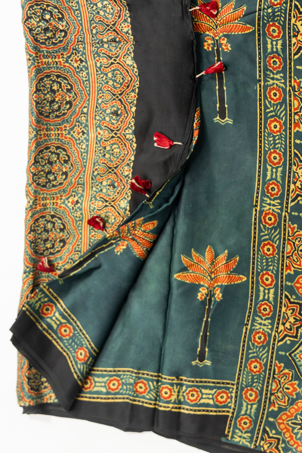 Dark bottle green Ajrakh saree with orange palm tree motifs