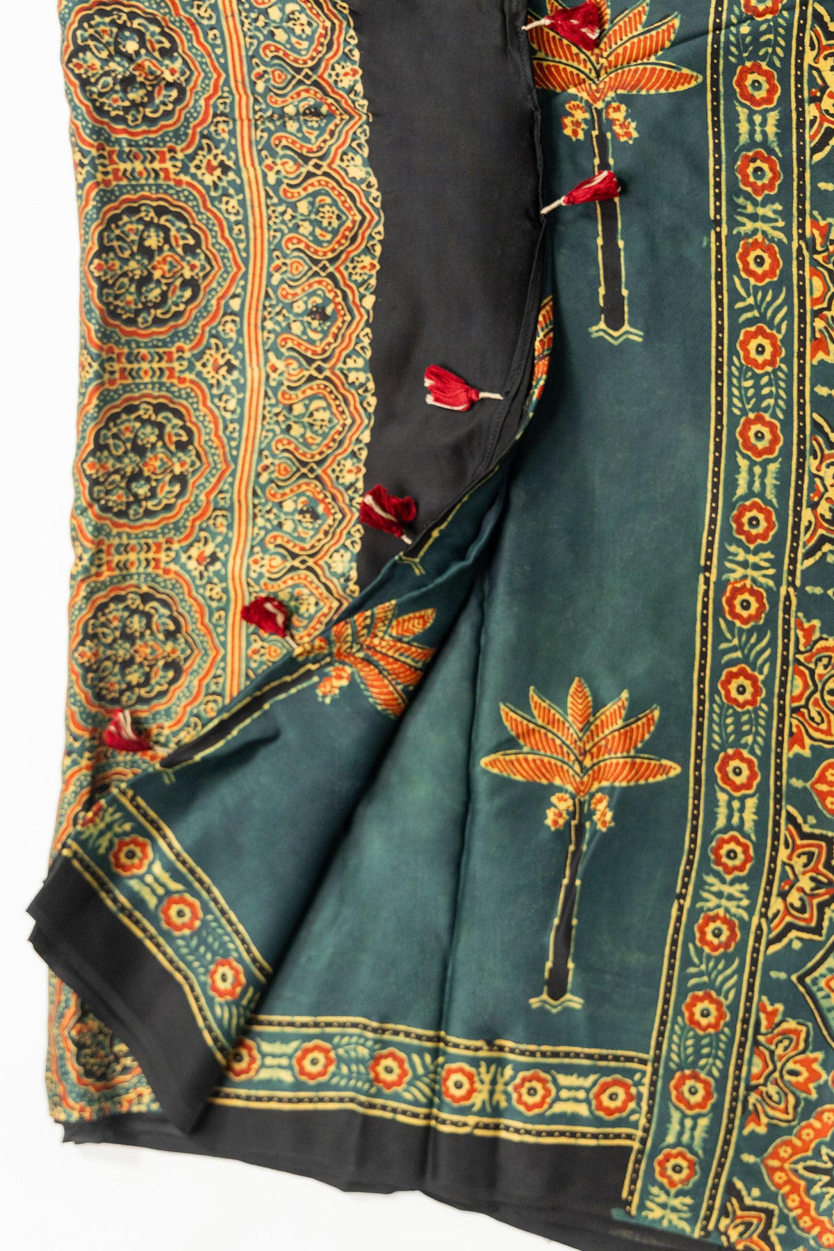 Dark bottle green Ajrakh saree with orange palm tree motifs