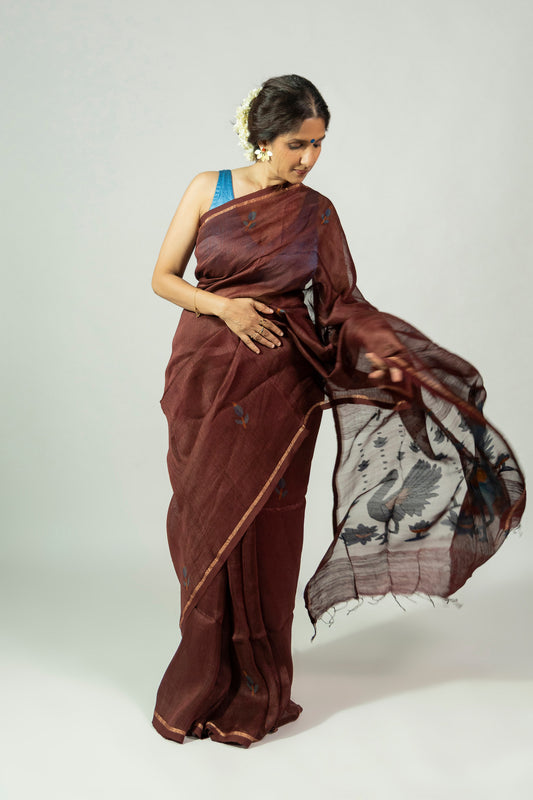 Padma Raat dark brown silk linen saree with blue leaf motifs and peacock pallu