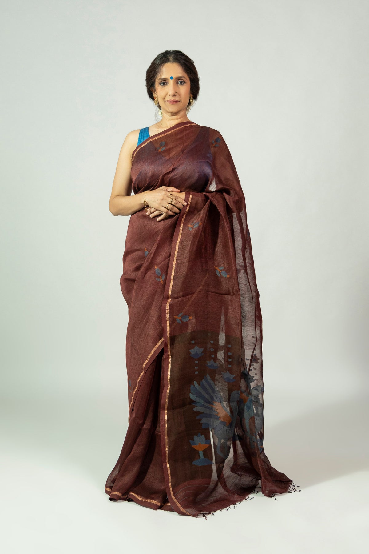 Dark brown silk linen saree with blue leaf motifs